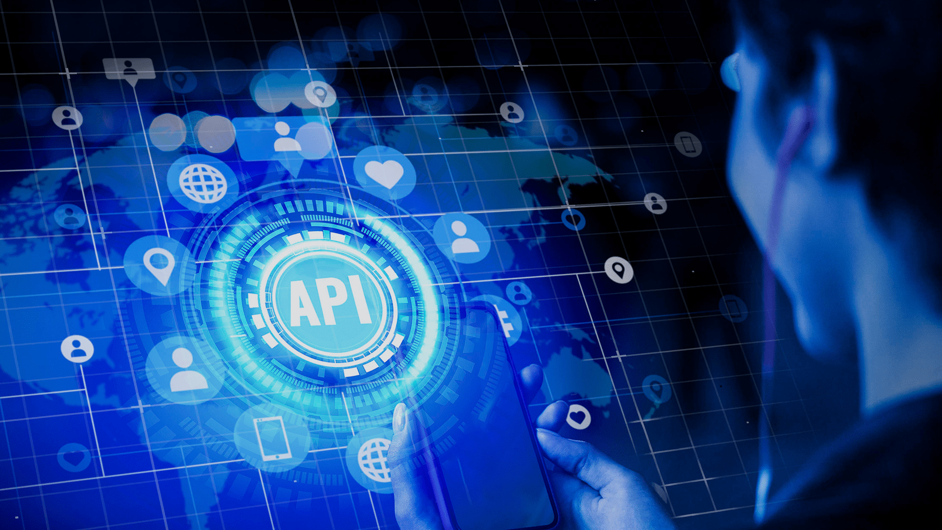 Pessoa segura um celular diante de uma interface digital azul com ícone central “API” e diversos símbolos de conectividade e rede ao fundo.